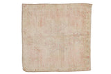 Distressed Oushak square rug with a subtle center medallion in faded pink, beige, and ivory.