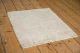 Distressed Oushak square rug mat with faded medallion, pale pink and ivory tones.