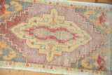 Distressed vintage Oushak rug pile with knot heads, visible foundation, geometric saffron medallion.