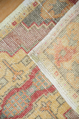 Distressed Oushak rug mat with mostly even wear, geometric patterns, and original side selvage.