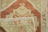 Vintage distressed Oushak rug corner with copper, seafoam worn pile and visible woven reverse.