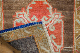 Blue side cord selvage and textured reverse foundation of vintage distressed Oushak rug.
