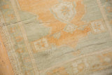 Distressed Oushak runner pile, worn knot heads and faint foundation in gold and sage.