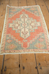 Distressed pile texture and stepped medallion on a vintage Oushak rug.