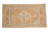 Distressed vintage Oushak rug, faded diamond medallion in terracotta, ivory, and aubergine.