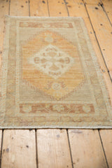 Aged side selvage of a distressed vintage Oushak rug, with muted ivory and pale terracotta tones.