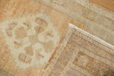 Worn pile of a vintage distressed Oushak rug, revealing soft floral motifs and its woven back.