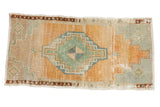 Distressed vintage Oushak rug with a central pinwheel medallion, faded teal, ivory, and abrash orange, 1'6