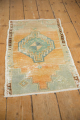 Distressed pile texture and mostly intact side selvage of a vintage Oushak rug.