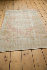 Distressed texture of vintage Oushak rug, showing mostly worn pile and faded blush tones.