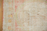 Worn pile with exposed foundation and intact side cord on this distressed Oushak rug.