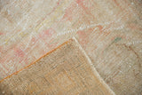 Distressed pile of vintage Oushak rug showing exposed foundation and intact side selvage.