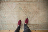 Distressed vintage Oushak runner featuring even worn pile, abrash, and pale blue floral designs.