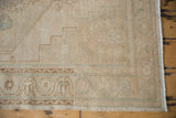 Distressed Oushak runner with even pile wear, subtle floral motifs, and muted beige hues.