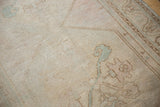 Distressed vintage Oushak runner texture with faint foundation, pale blush and blue.