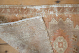 Distressed hand-knotted Oushak rug pile texture, foundation weave, and apricot, beige tones.
