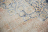 Vintage Distressed Oushak carpet texture with worn pile in pale dusty rose, cobalt blue, ivory, and sand.