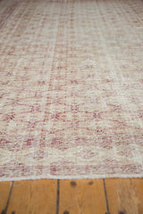 Distressed Oushak carpet pile texture, faded cherry red and ivory, with foundation showing.