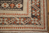 Distressed Oushak rug corner, cherry red, charcoal, ivory geometric guls and pawn motif.