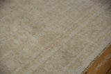 Distressed vintage Oushak rug close-up showing even pile wear, wefting speckling, and original side selvage.