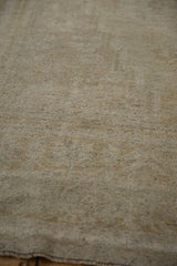Pale olive and ivory distressed Oushak pile, showing even wear and speckled wefting.