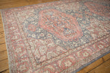 Terra cotta, dusty denim blue floral vinery on distressed vintage Oushak carpet.