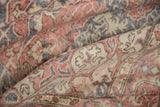 Distressed Oushak carpet detail showing worn pile, vinery, terra cotta, and dusty blue.