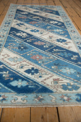 Distressed Oushak runner, blue and ivory diagonal stripes featuring delicate floral vinery.