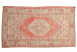 Distressed vintage Oushak rug, stepped medallion, geometric designs; pale red, beige, powder blue.