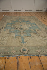 Perspective view of the vintage distressed Oushak rug, showing its soft even wear and wool texture.