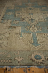 Angled detail of the distressed, even wear across the pile of a vintage Oushak rug.