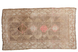 Distressed vintage Oushak carpet with geometric paneled medallions in silver, gray, and pink.