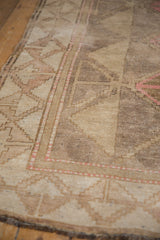 Distressed Oushak carpet showing tone-on-tone abrashes and geometric paneled motifs.