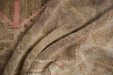 Textured pile of vintage distressed Oushak rug, showing abrashes and soft pink patterns.