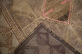 Distressed Oushak rug pile with faded pink geometric pattern and tightly hand knotted back.