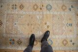 Distressed Oushak runner with faded saffron, ivory, and sapphire geometric motifs.