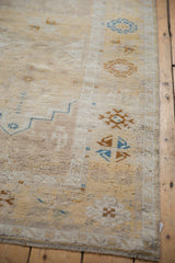 Textured vintage Oushak runner showcasing pale saffron, sapphire blue plant motifs with wear.