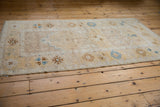 Distressed vintage Oushak runner pile with ivory, sapphire blue, and saffron geometric designs.