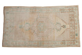 Vintage Distressed Oushak rug with stepped medallion in muted blue and sand tones.
