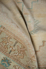 Distressed vintage Oushak rug pile texture with mostly even wear and faded silver, dusty teal hues.