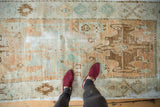 Distressed Vintage Oushak runner featuring worn pile, exposed foundation, and seafoam geometric florals.
