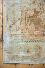 Distressed vintage Oushak runner showing worn geometric patterns and visible foundation.
