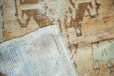 Distressed vintage Oushak rug pile with exposed knot heads and hand-knotted foundation.