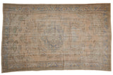 Distressed vintage Oushak hand-knotted carpet, faded apricot and dusty blue medallion.