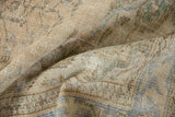 Close-up of hand-knotted Oushak rug pile, distressed with mostly even wear and muted beige tones.