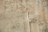 Vintage Distressed Oushak carpet's worn pile, visible woven foundation, and side cord selvage.