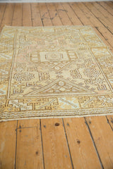 Distressed pile texture with simplistic hook and latch motifs on vintage Oushak rug.