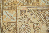 Textured vintage Distressed Oushak rug with geometric hook and latch pattern in pale gold and mint.