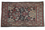 Distressed Oushak rug, navy field with red-gold florals and cloudband border, 4'1