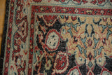 Distressed vintage Oushak rug corner, cherry red, gold, charcoal tendrils and cloudband.
